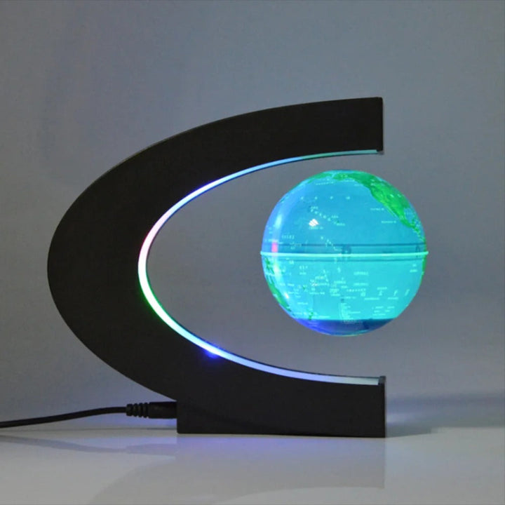 Levitating globe with LED lighting on a black stand against a gray background