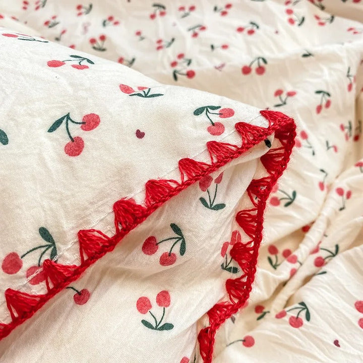 Red crochet trim detail on soft cherry print fabric, combining durability and decorative elegance