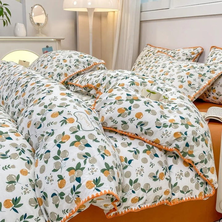Orange citrus patterned bedding set with decorative edge, adding freshness to minimalist interiors