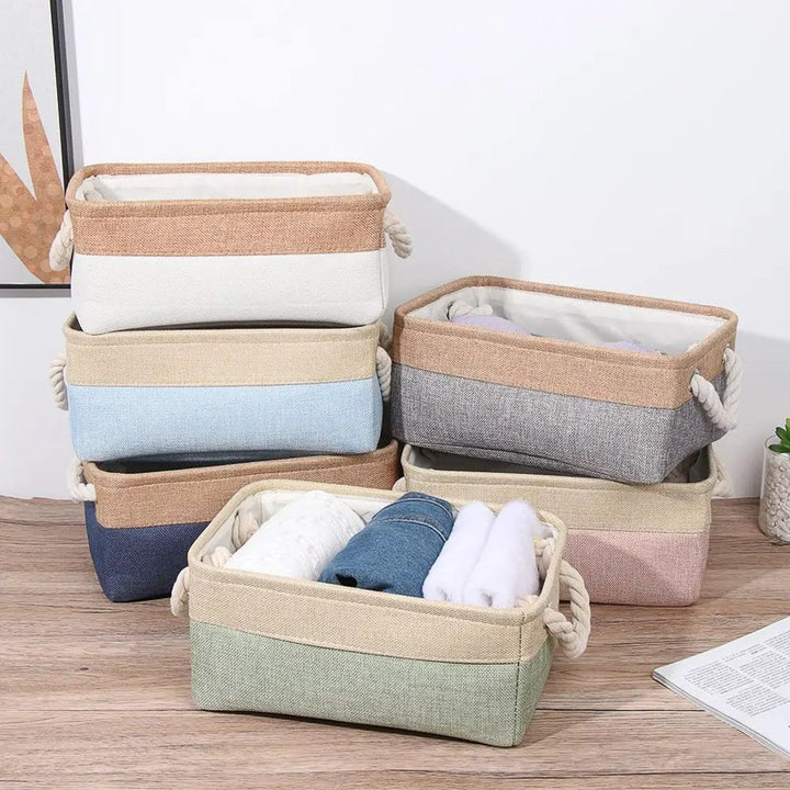 Set of colorful fabric storage baskets on a wooden floor.