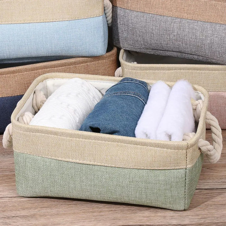 Storage basket with rolled-up clothes on a wooden surface