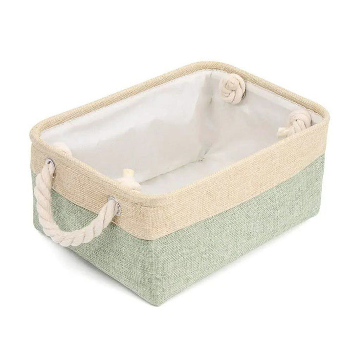 Storage basket with green base and beige top on a white background