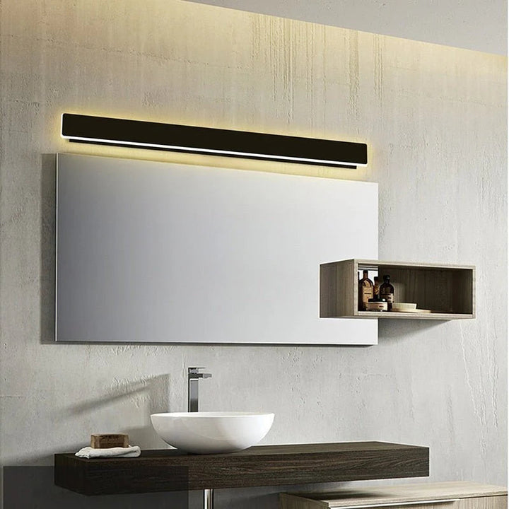Black LED wall light above bathroom mirror providing soft ambient illumination in modern interior