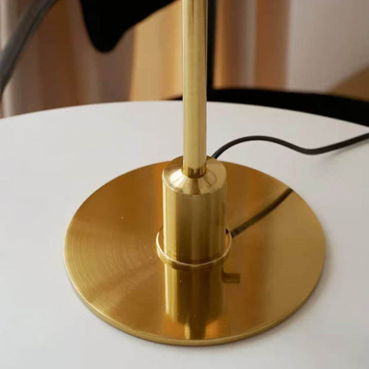 Gold table lamp base on a white surface