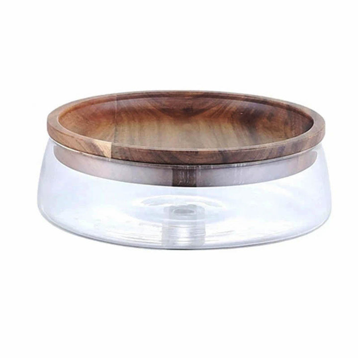 Clear glass storage container with wide base and smooth acacia wood lid, modern Nordic design.