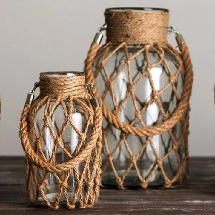 Two glass vases with rope netting on a wooden surface