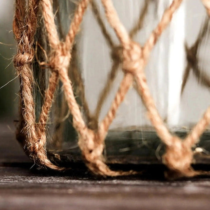 Glass jar with rope lid on a wooden surface