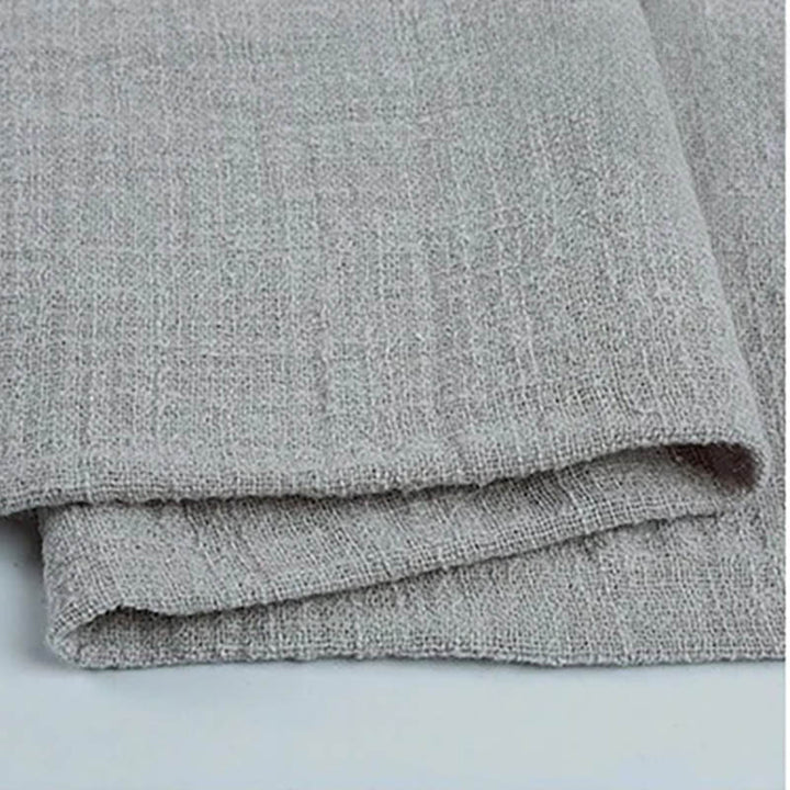Folded grey cotton napkin for Weddings and Elegant uk Dining Decor on the white table.