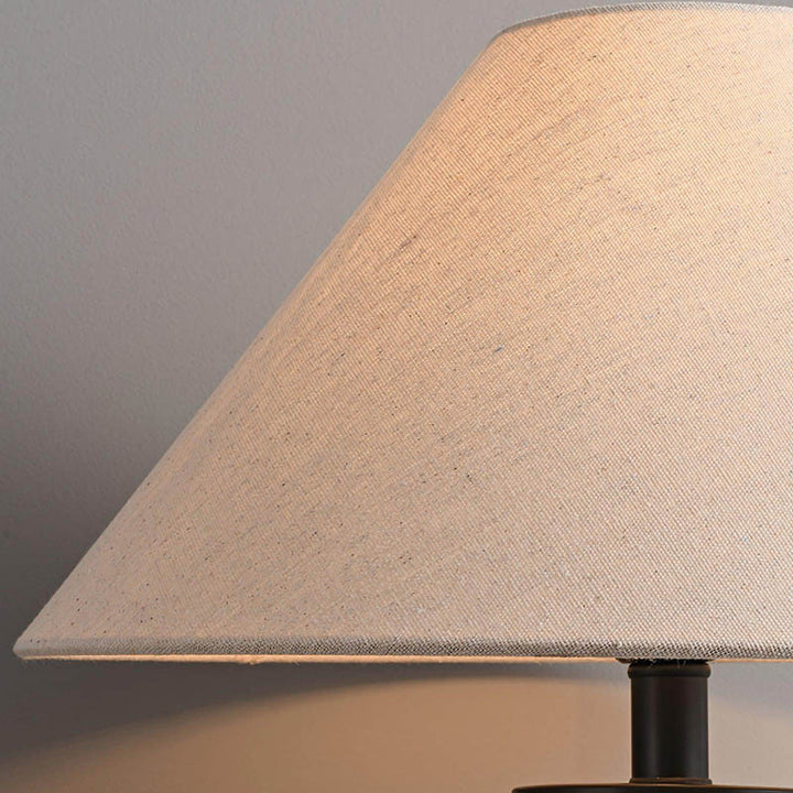 Close-up of HANDLAVET ceramic handcrafted table lamp's natural cotton fabric shade