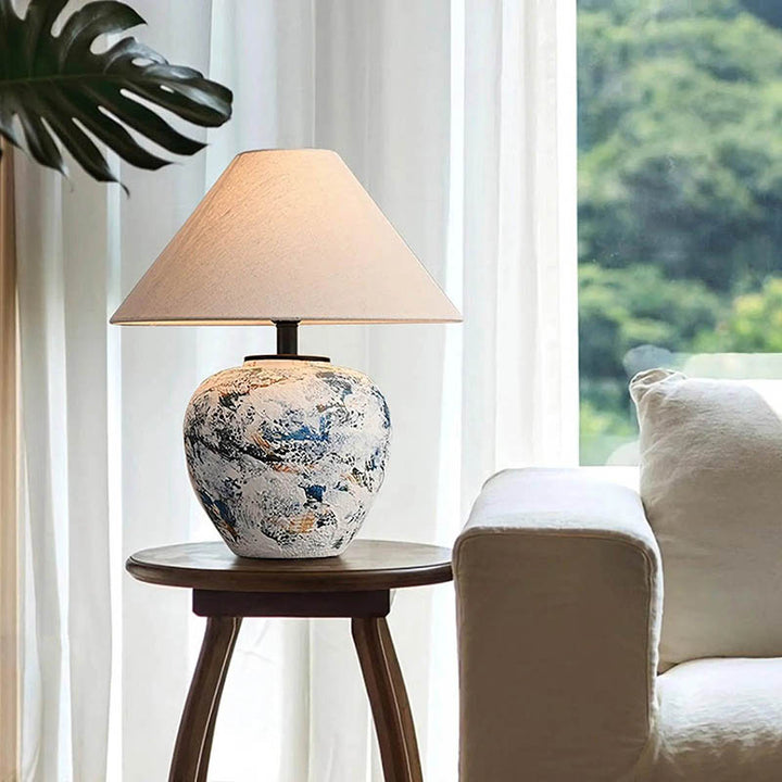 HANDLAVET ceramic handcrafted table lamp with a cotton fabric shade, featuring a modern Nordic design for warm ambient lighting.