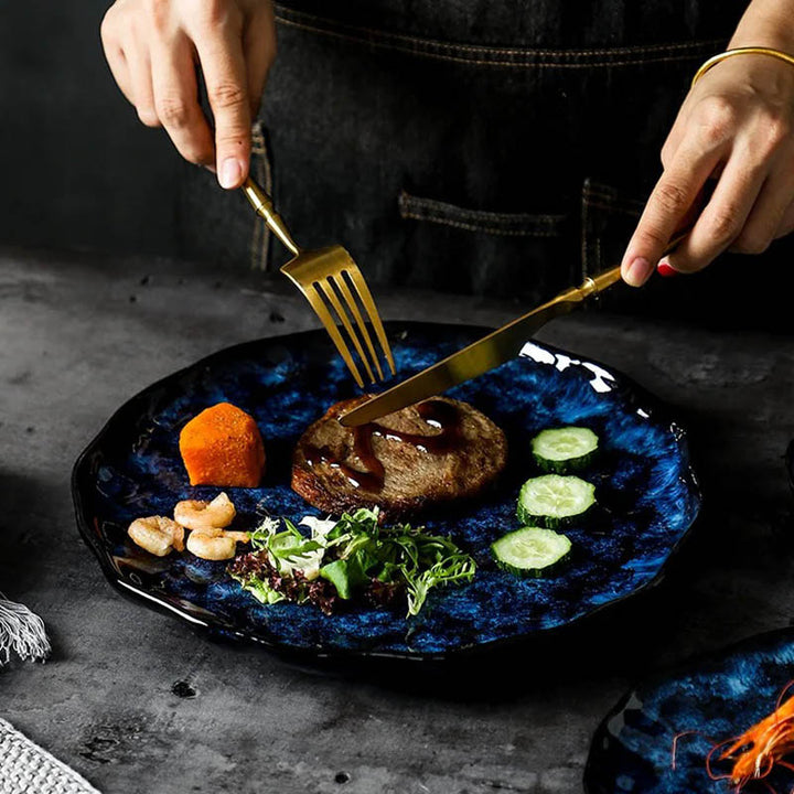Elegant navy ceramic dinner plate with modern textured finish, ideal for serving steak and fresh vegetables