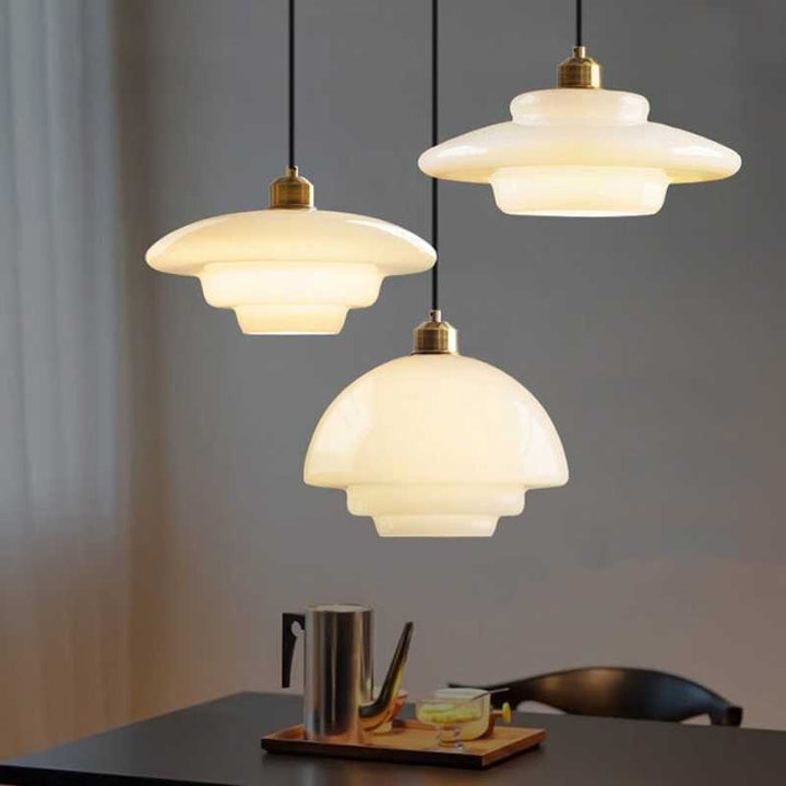Set of HAVEN white glass pendant lamps hanging above dining table, Nordic inspired interior lighting