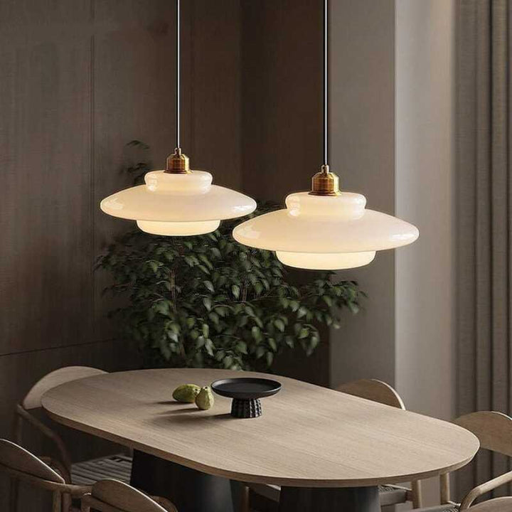 Two HAVEN cream glass pendant lamps above dining table, mid-century style for modern interiors