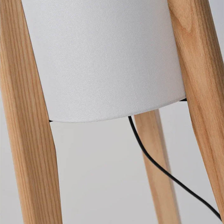 Close-up of natural wood frame and cable entry point on the HOJ tall fabric floor lamp.