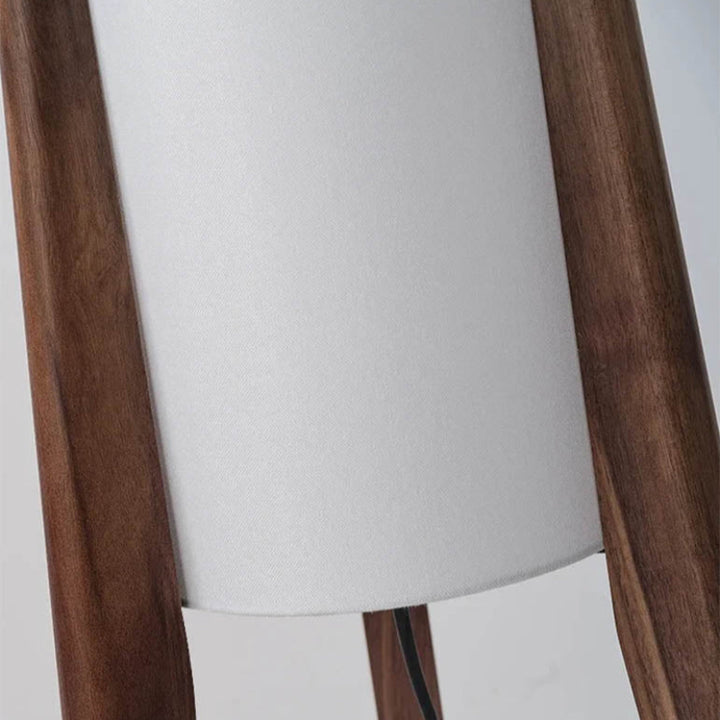 tall Japanese lamp illuminating a warm-toned shelf area, ideal for calming home decor.