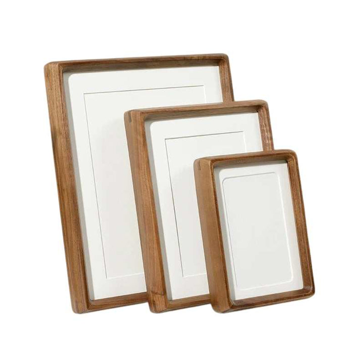 Set of handcrafted wooden photo frames in multiple sizes, featuring smooth rounded edges for elegant home display