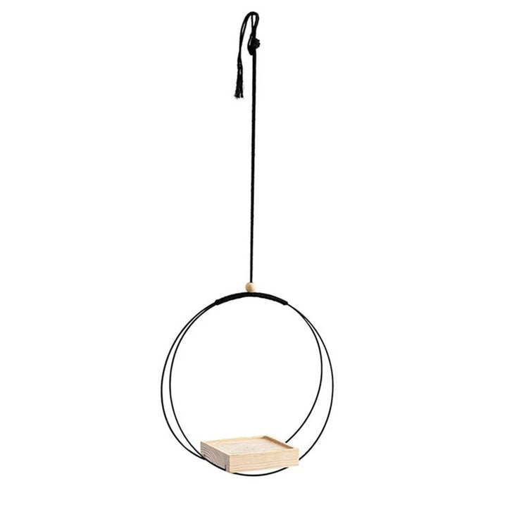 Circular hanging shelf with black iron frame and light wood platform, minimalist design perfect for small indoor plants.