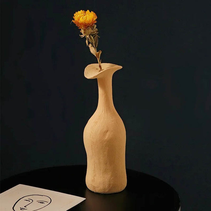Yellow ceramic vase with curved top, ideal for single-stem flowers and Scandinavian-style interior decoration