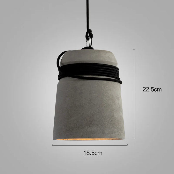 Concrete pendant light with black cord on a gray background