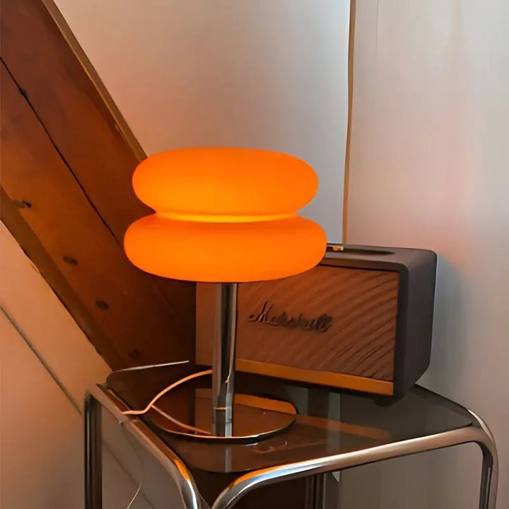 Warm orange glass table lamp with chrome base, USB-powered, ideal for modern Scandinavian bedroom lighting.