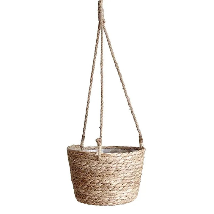 Woven hanging basket with rope handle on a white background