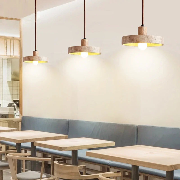 Trio of KLIPPE natural stone pendant lights in modern restaurant seating area