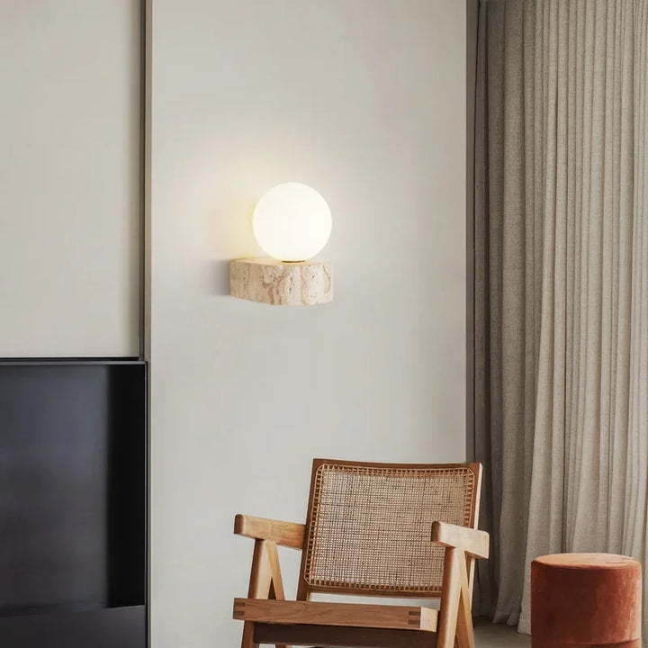 Natural stone wall lamp lighting up modern living room with wooden chair