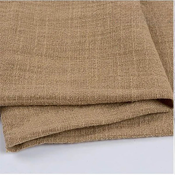 Folded khaki cotton napkin for Weddings and Elegant uk Dining Decor on the white table.