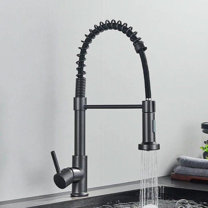 Black kitchen faucet with spring design on a gray background