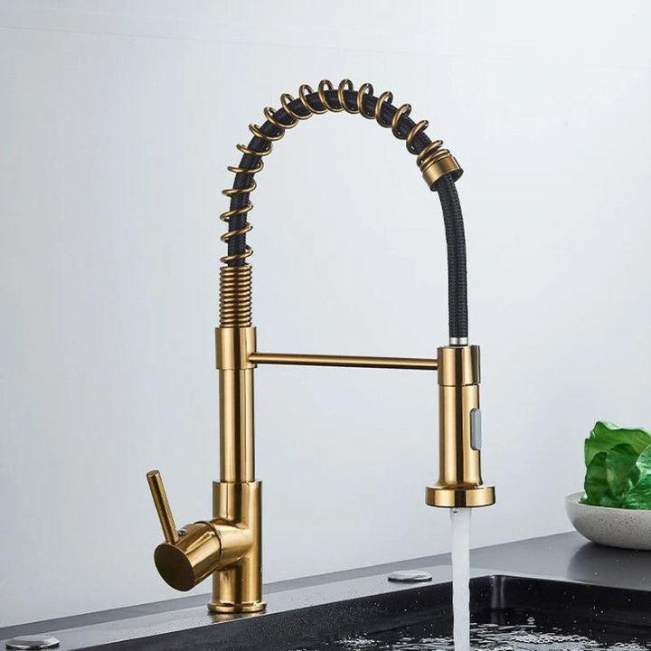 Gold kitchen tap with a modern design on a white background