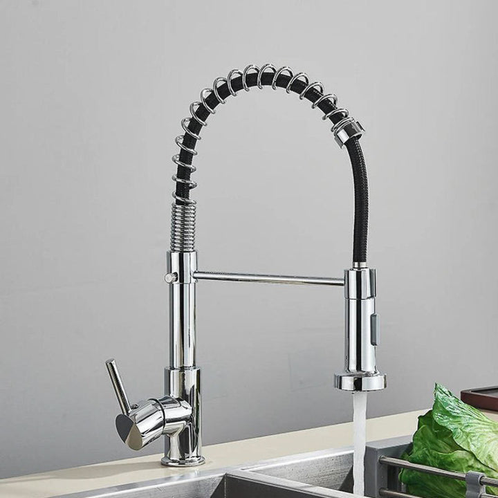 Chrome kitchen tap with pull-down sprayer on a gray background