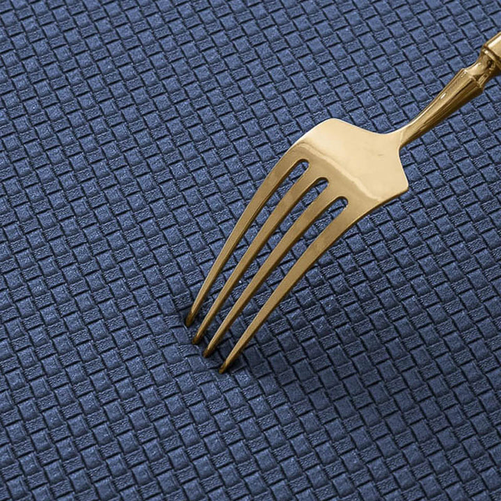 Gold fork on a textured blue surface