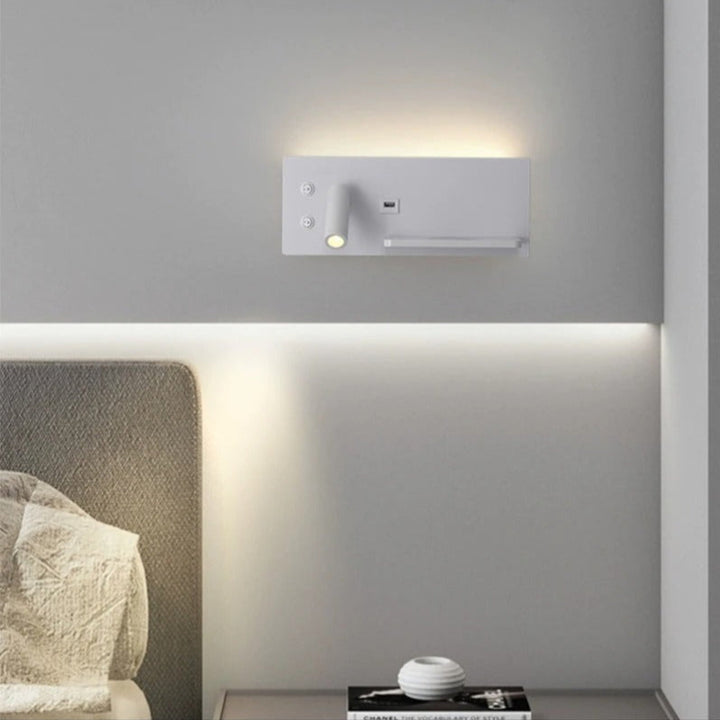 Wall-mounted light fixture on a gray wall with a Chanel product space below.