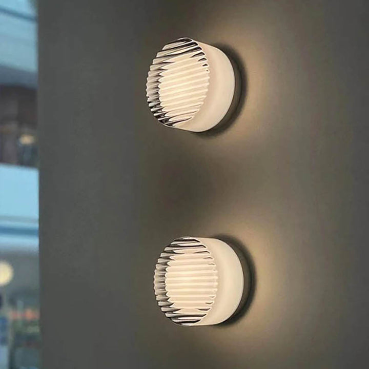 Two LYSEN Nordic LED wall sconces, minimalist metal lights with ribbed glass, glowing