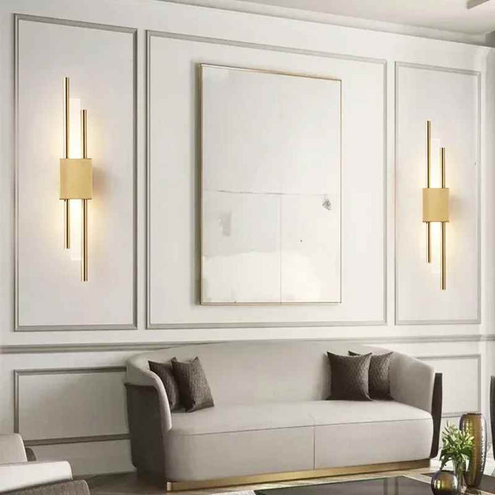 Elegant gold LED wall lights above grey sofa in modern living room interior
