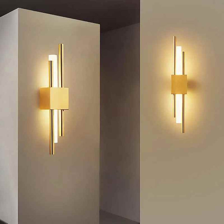 Pair of modern gold LED wall lamps illuminating beige hallway