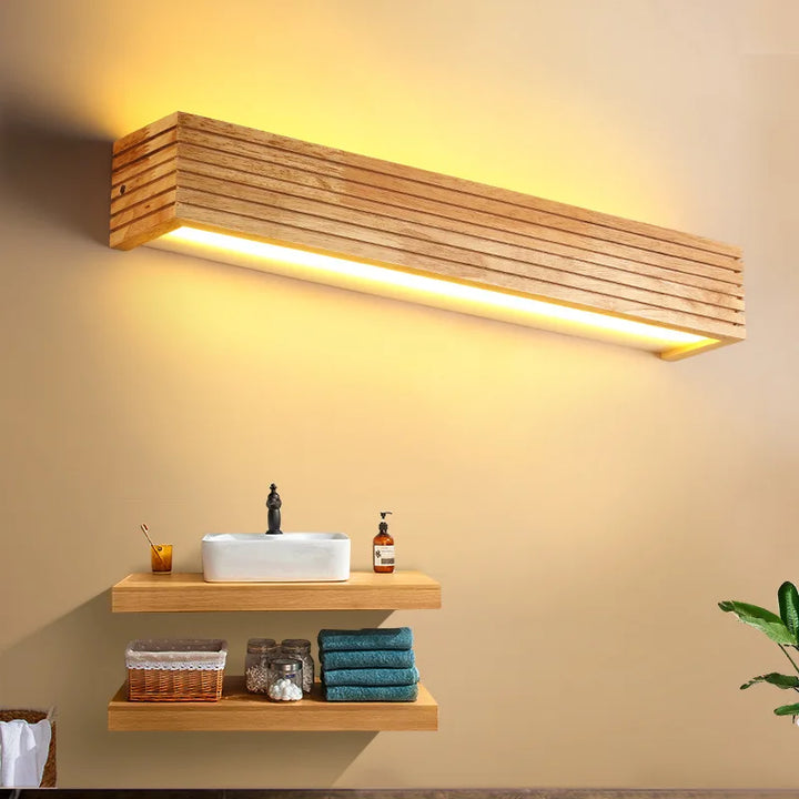 Long LYSE wooden LED wall lamp installed above bathroom sink for modern home décor