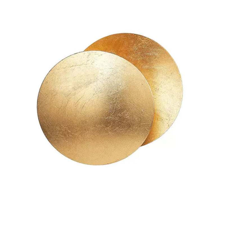 Elegant gold MÅNE Solar Eclipse Wall Light with overlapping circular discs casting a warm glow.
