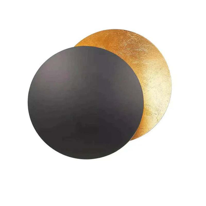 Black and gold MÅNE Solar Eclipse Wall Light combining matte black with radiant golden glow.