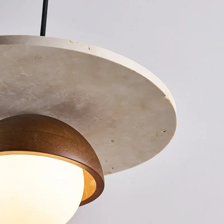 Close-up of walnut wood dome and marble plate pendant light with LED globe