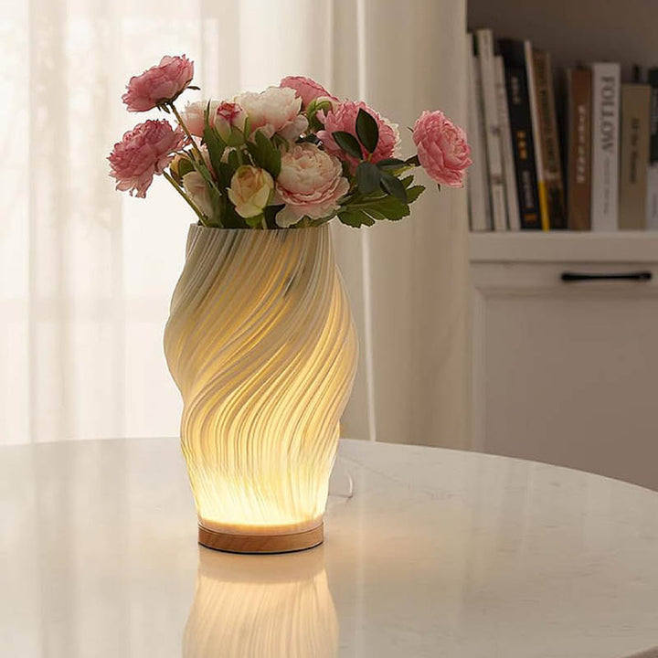 MOLLEN lamp used as a vase for pink flowers on a dining table, showcasing multifunctional decorative use.