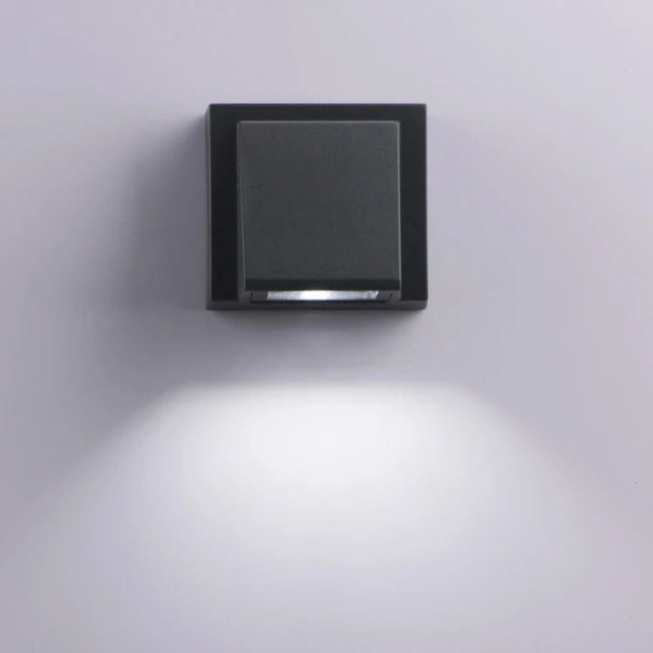 Square wall light fixture on a plain wall