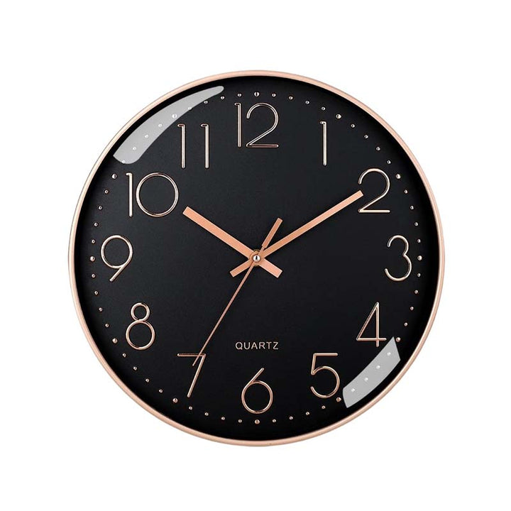 Black wall clock with rose gold hands on a white background