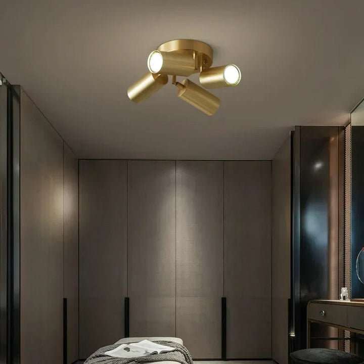 Gold ceiling light fixture in a modern bedroom setting