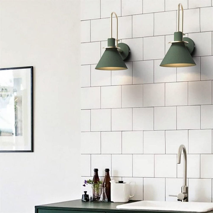Kitchen with white tiled wall, green wall lights, and a sink.