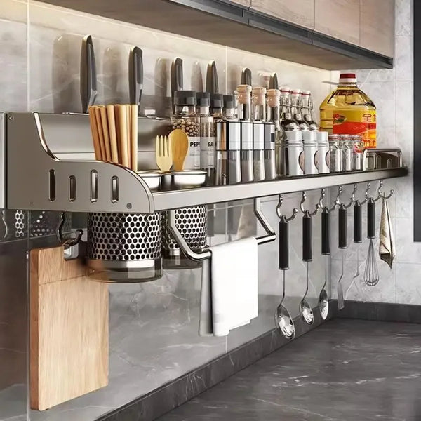 Modern kitchen storage rack with hanging utensils against a tiled wall.