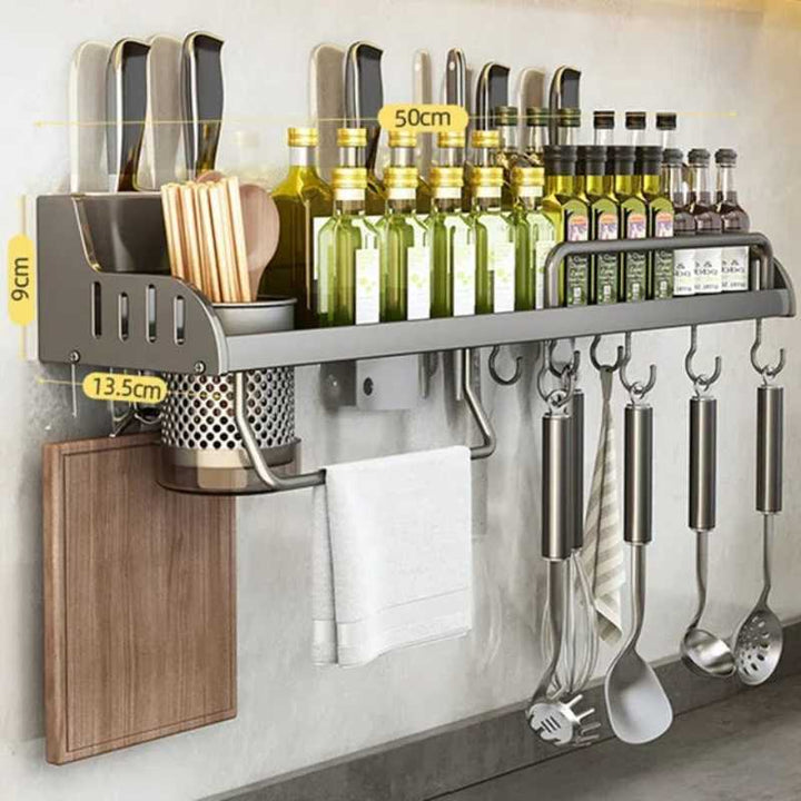 Kitchen wall-mounted organizer with bottles, utensils, and cutting board.
