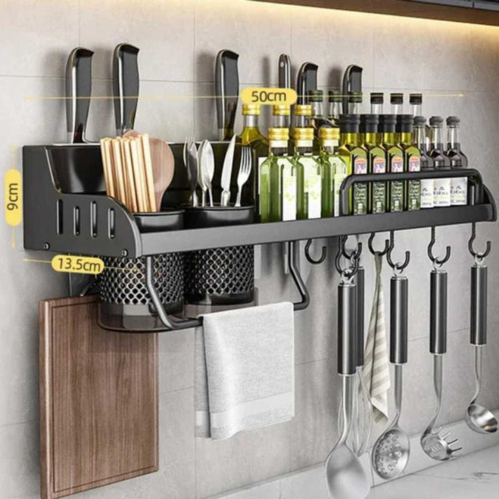 Kitchen wall-mounted organizer with utensils, bottles, and a cutting board.