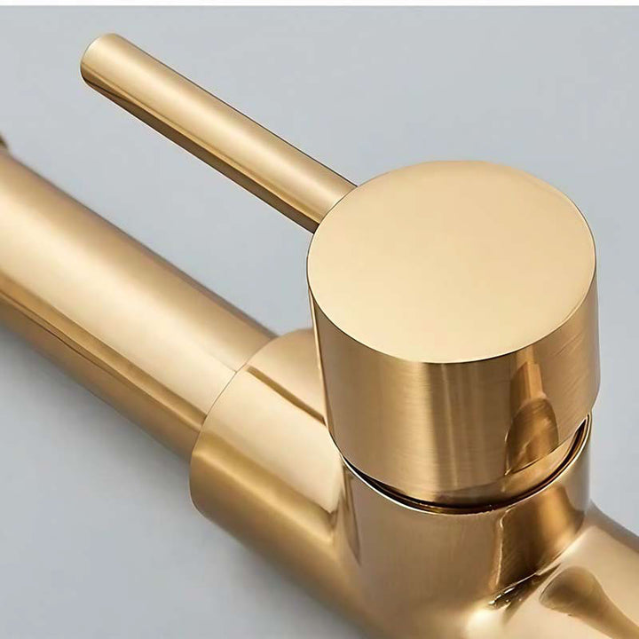 Gold faucet on a light gray background