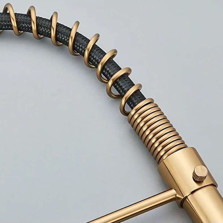 Gold and black coiled hose on a light gray background